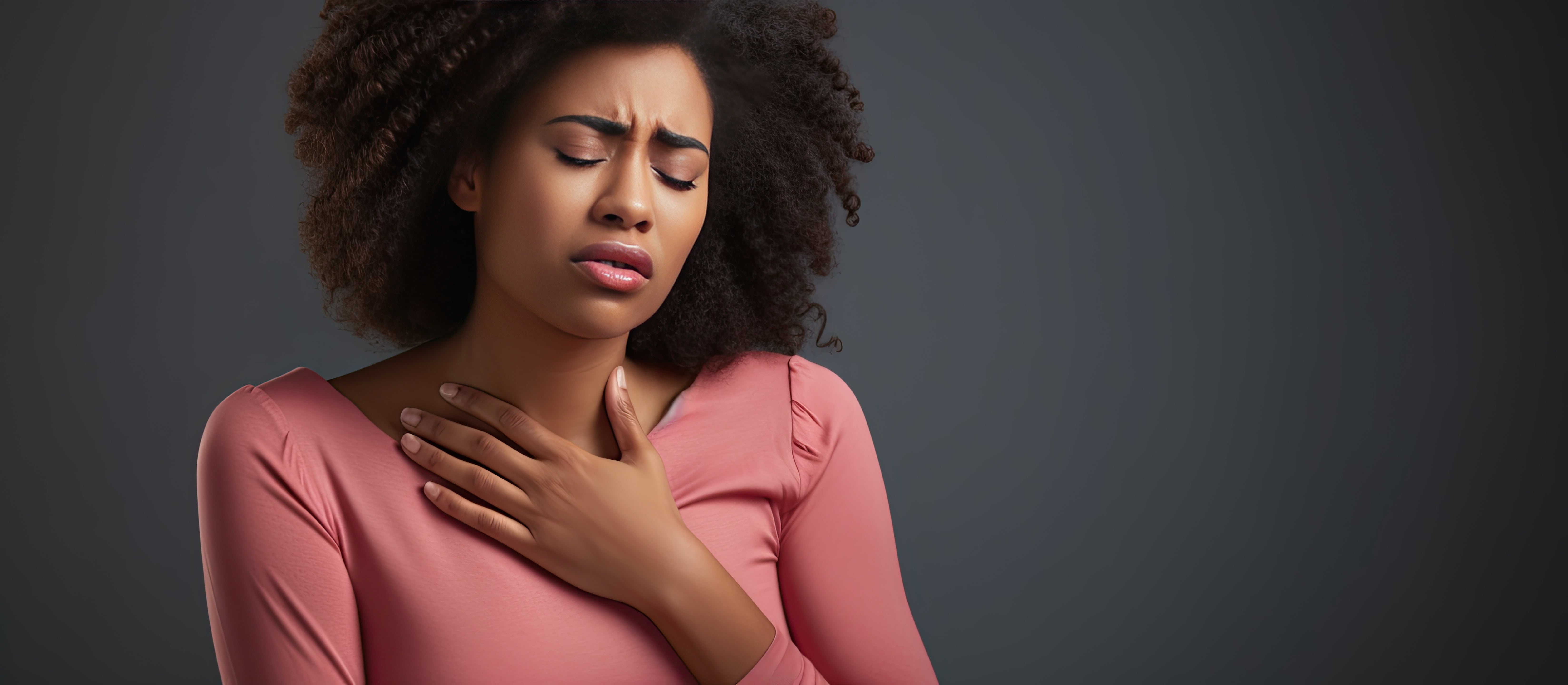 Person experiencing acid reflux and bloating, holding their throat in discomfort.